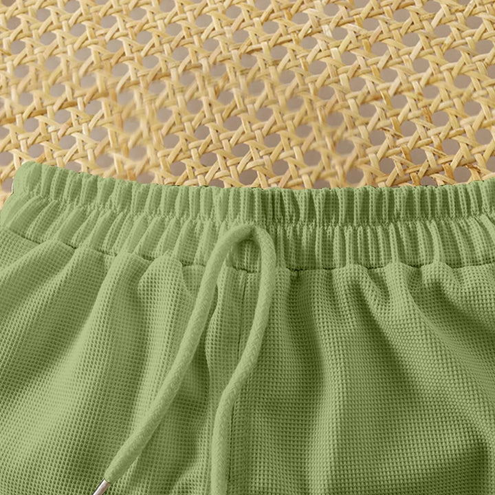 Green textured fabric with a woven beige background