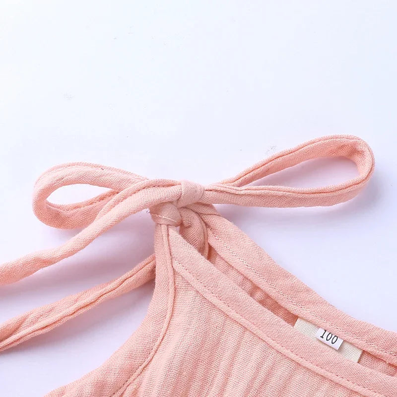 Pink bikini top with a bow on a light pink background