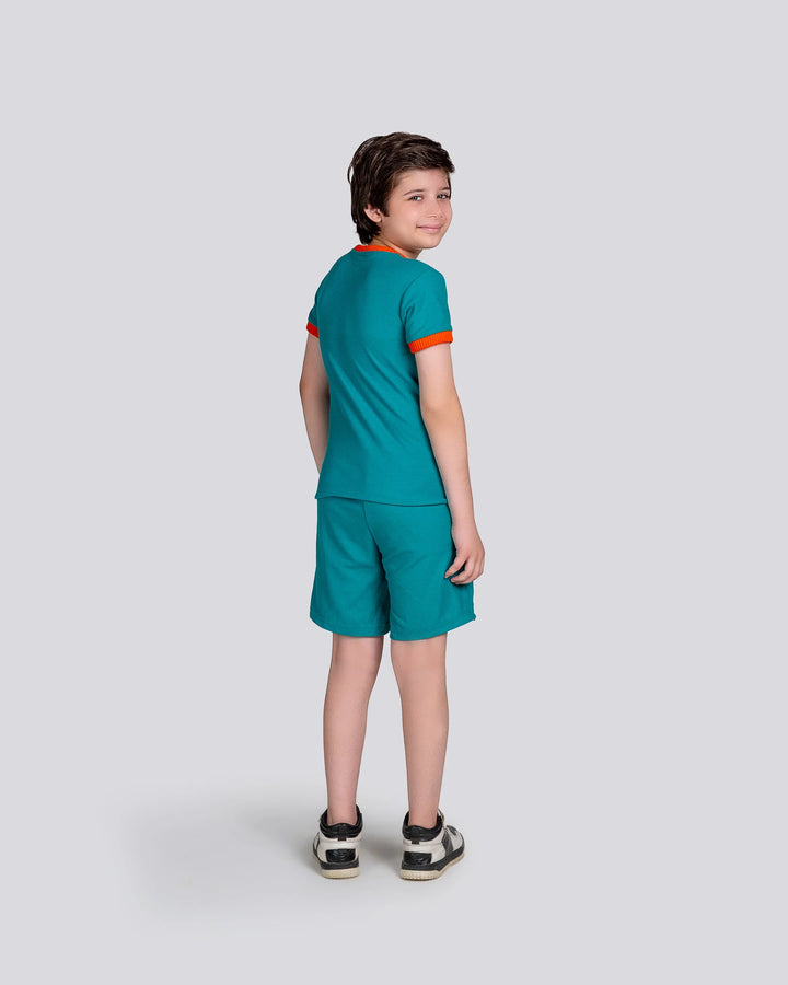 Child wearing a teal sports outfit with orange trim on a white background