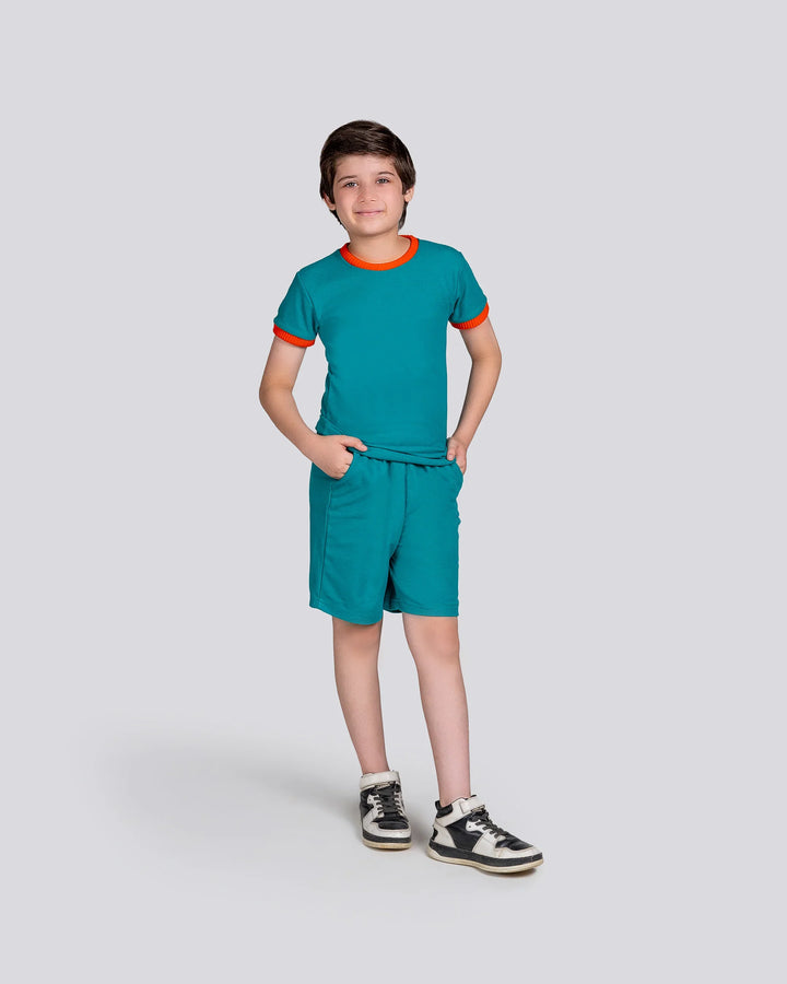 Child wearing a teal outfit with orange accents on a white background