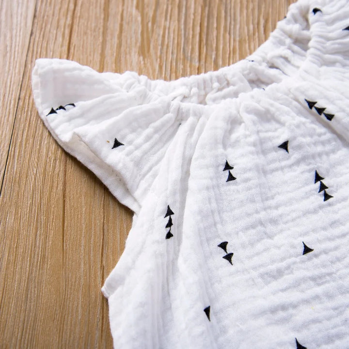 White fabric with black triangle patterns on a wooden surface