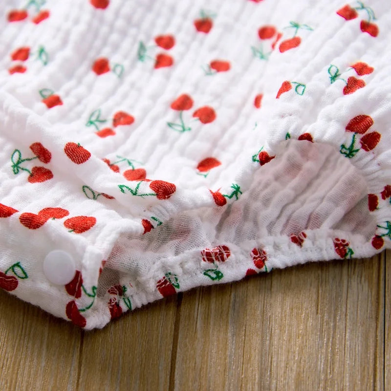 White fabric with red floral patterns on a wooden surface