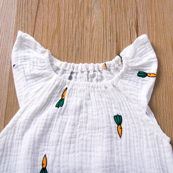 White dress with carrot patterns on a wooden surface