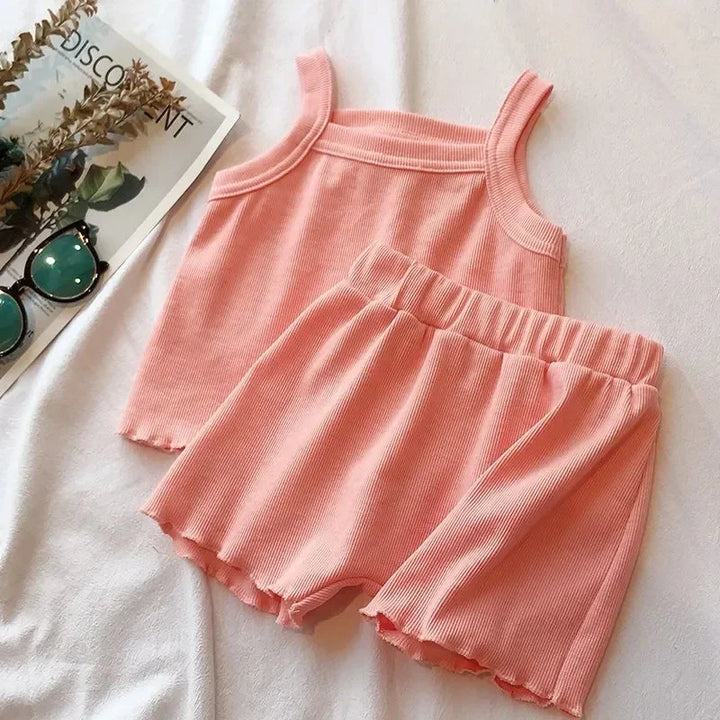 Pink ribbed tank top and shorts set on a light background