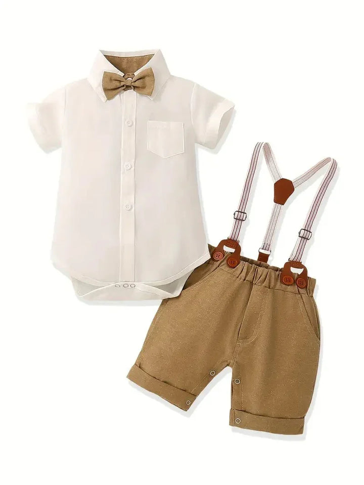Baby outfit with white shirt, brown shorts, suspenders, and bow tie on a white background