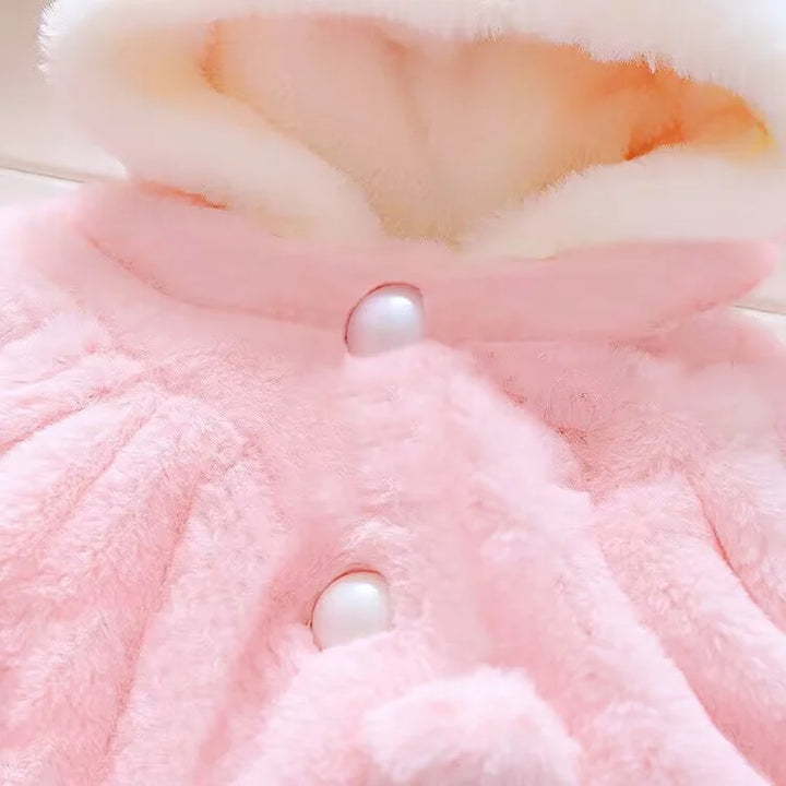 Close-up of pink plush toy with a pearl-like button
