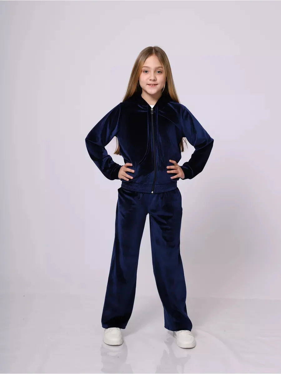 Girl wearing a navy tracksuit on a white background