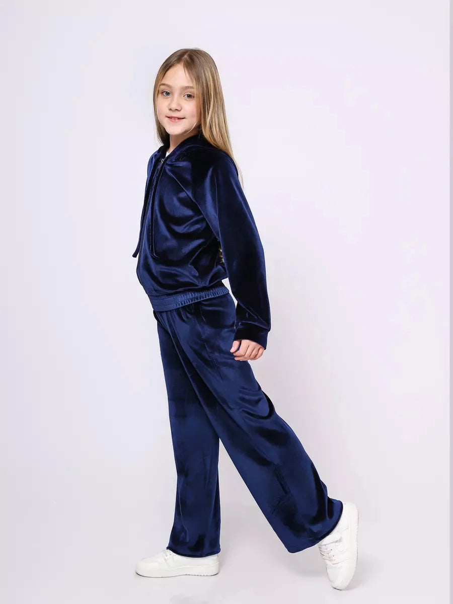Girl wearing a navy blue tracksuit on a white background
