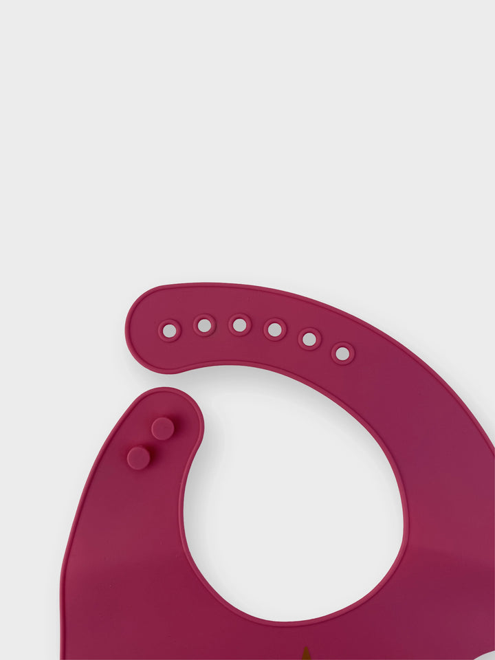 Pink silicone bib on a white background