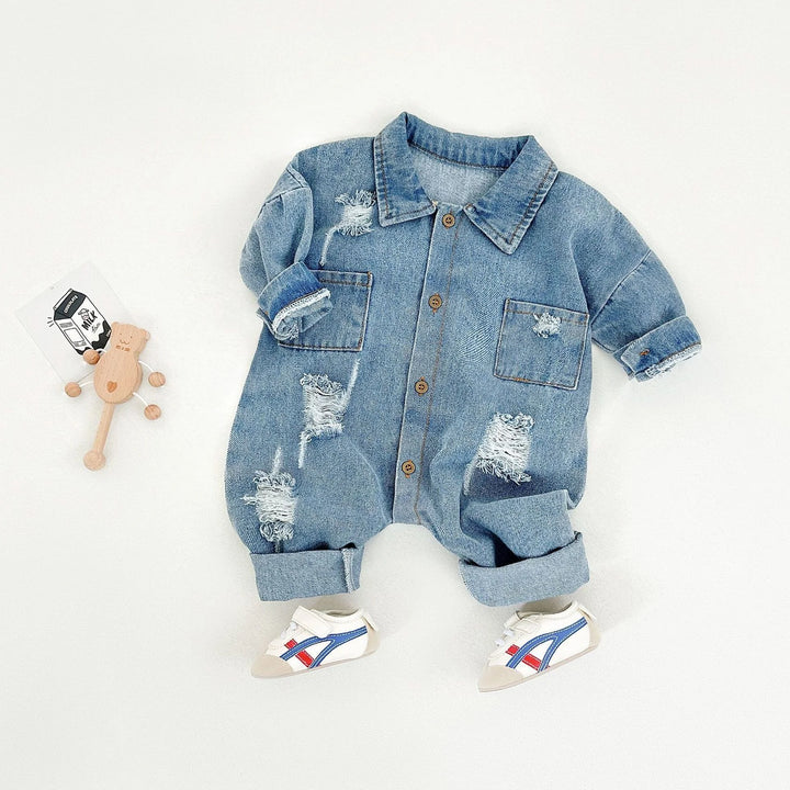 Denim baby outfit with distressed details on a white background