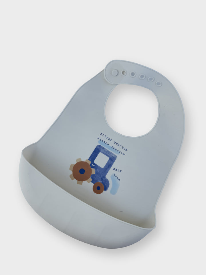A silicone waterproof bib with a food catcher pocket and a playful vehicle print.
