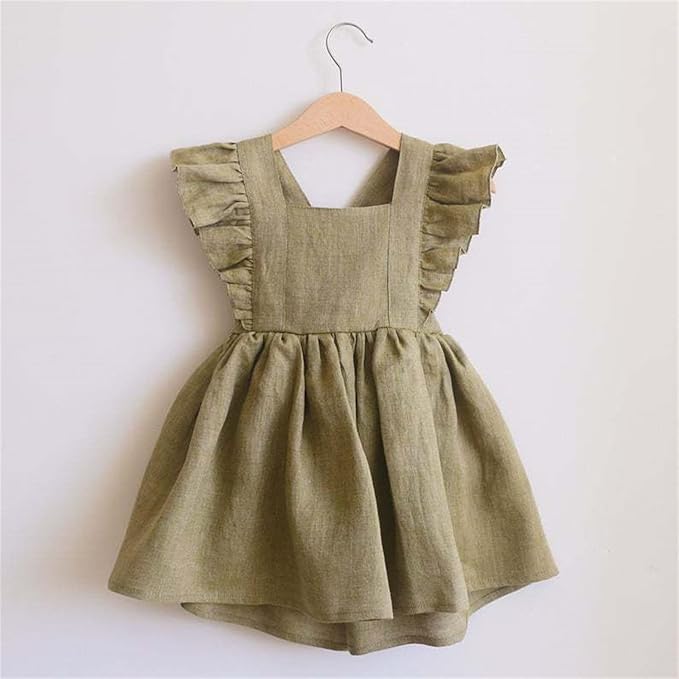 Green dress with ruffled sleeves on a wooden hanger against a white background