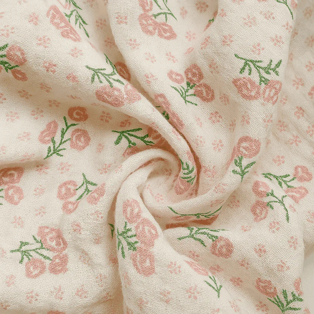 Close-up of fabric with pink floral pattern on a beige background