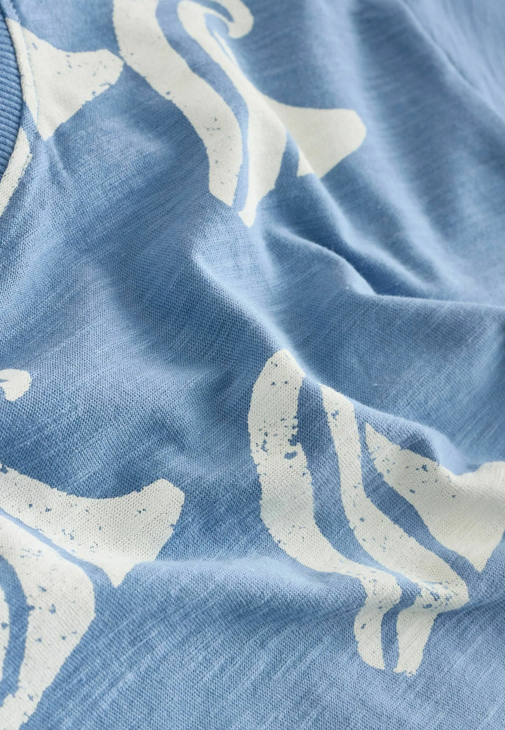 Close-up of blue fabric with white whale prints