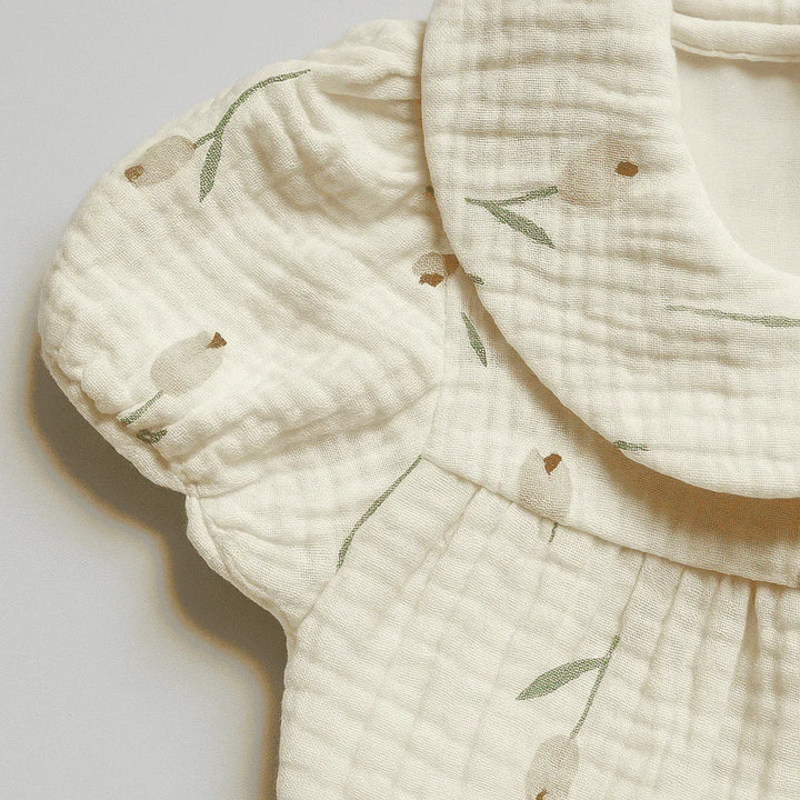 Close-up of a textured fabric with floral patterns on a light background