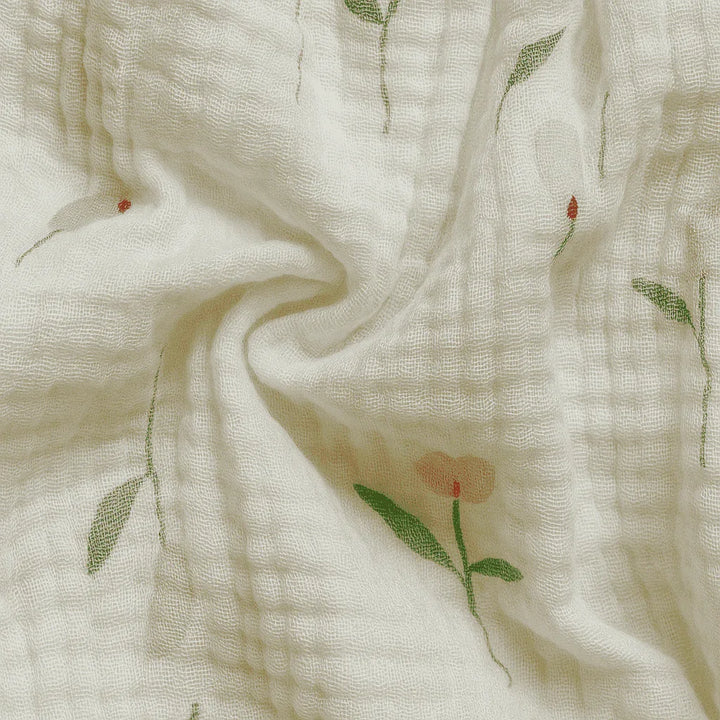 Close-up of soft fabric with floral embroidery on a light background