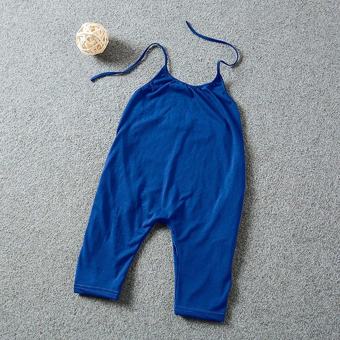 Blue baby romper on a textured gray surface