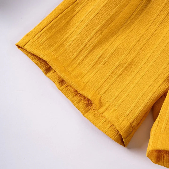 Close-up of yellow fabric on a white background