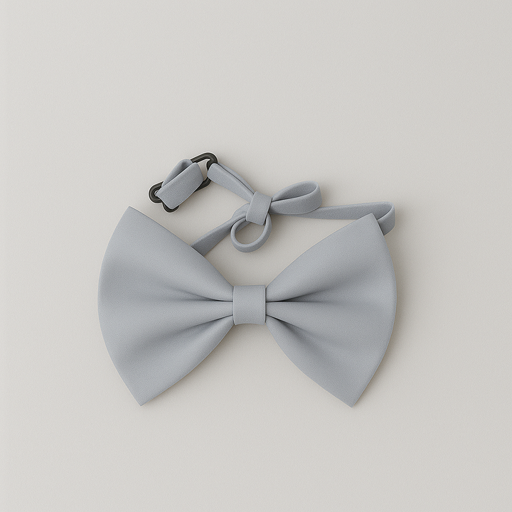 Light grey baby bow tie with an adjustable strap, displayed on a soft neutral background.