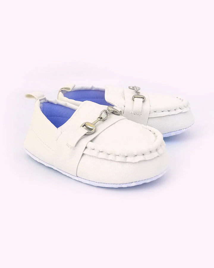 White baby shoes with blue soles on a white background