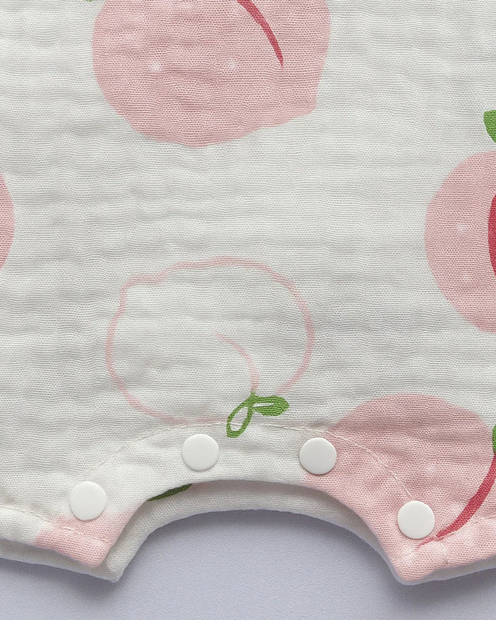 Baby bib with pink peach pattern on a light gray background