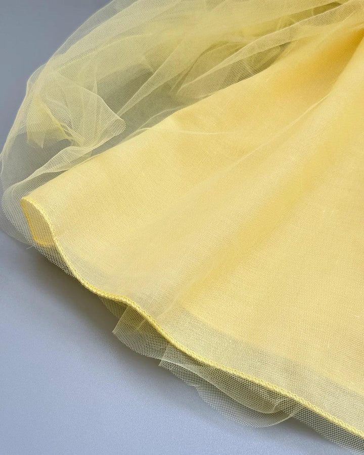 Yellow tulle fabric on a white background