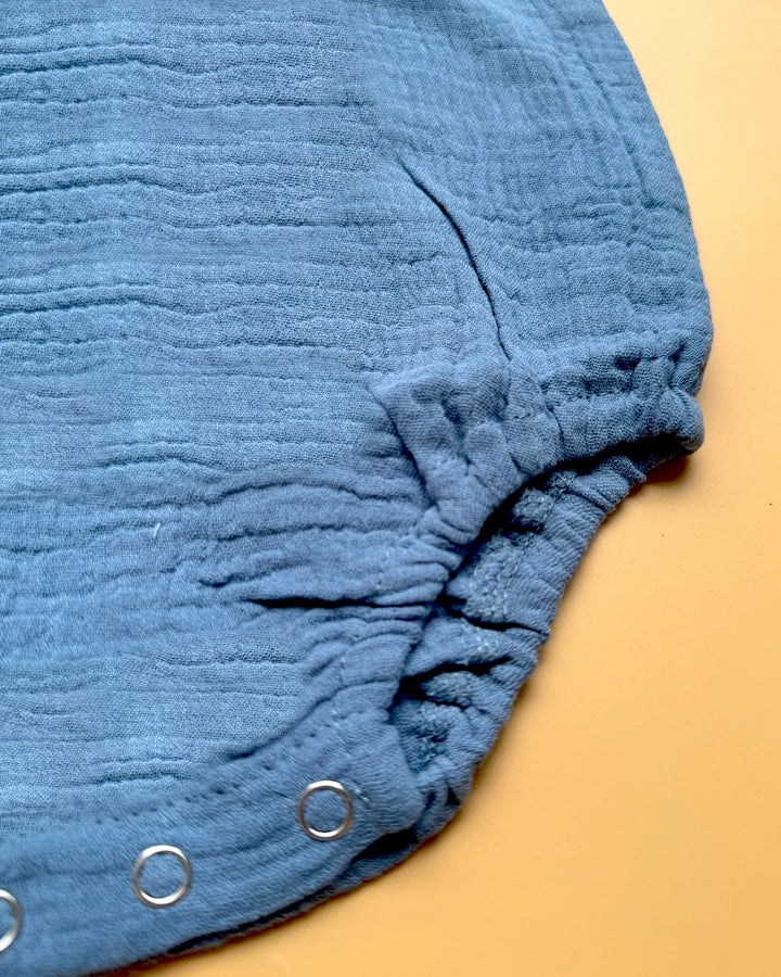 Blue textured fabric bloomers on a beige background