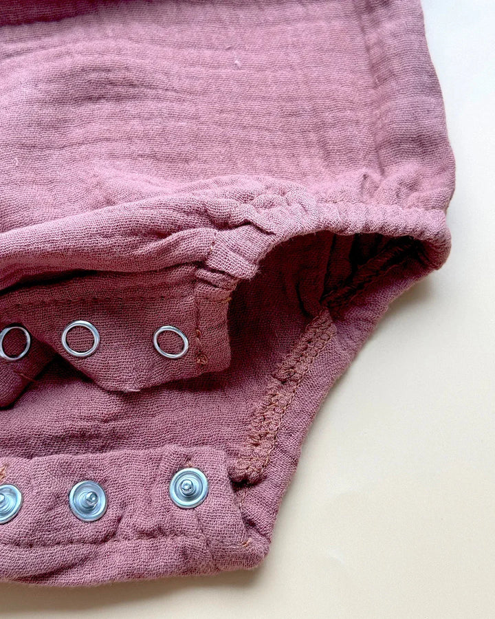 Close-up of pink fabric with grommets on a white background