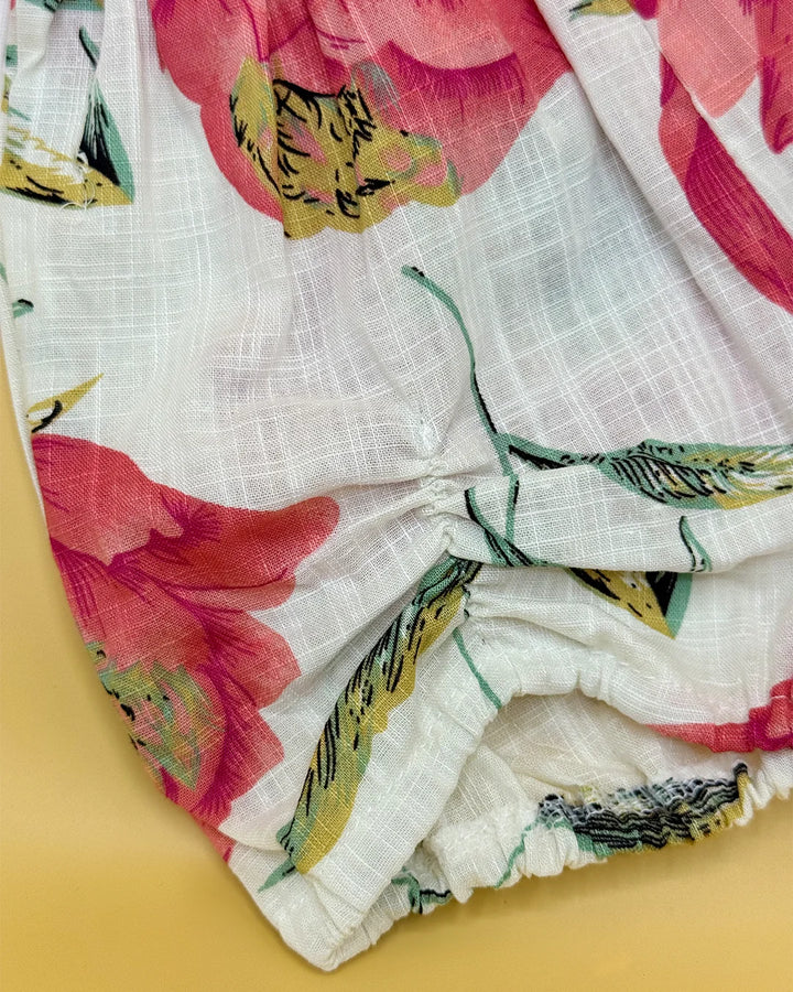 Floral fabric with pink and yellow flowers on a white background