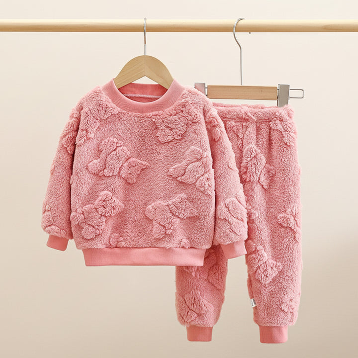 Pink fleece children's set with teddy bear pattern on a beige background