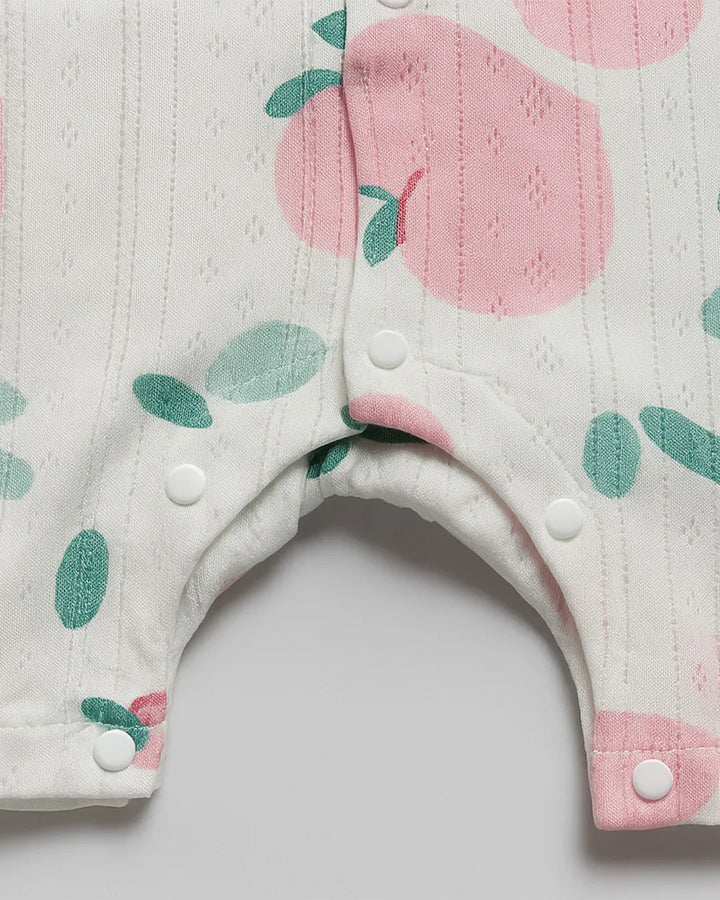 Baby bib with pink and green floral pattern on a white background