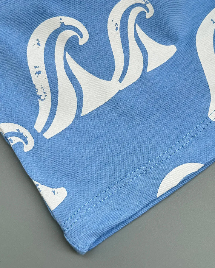 Blue fabric with white wave pattern on a gray background