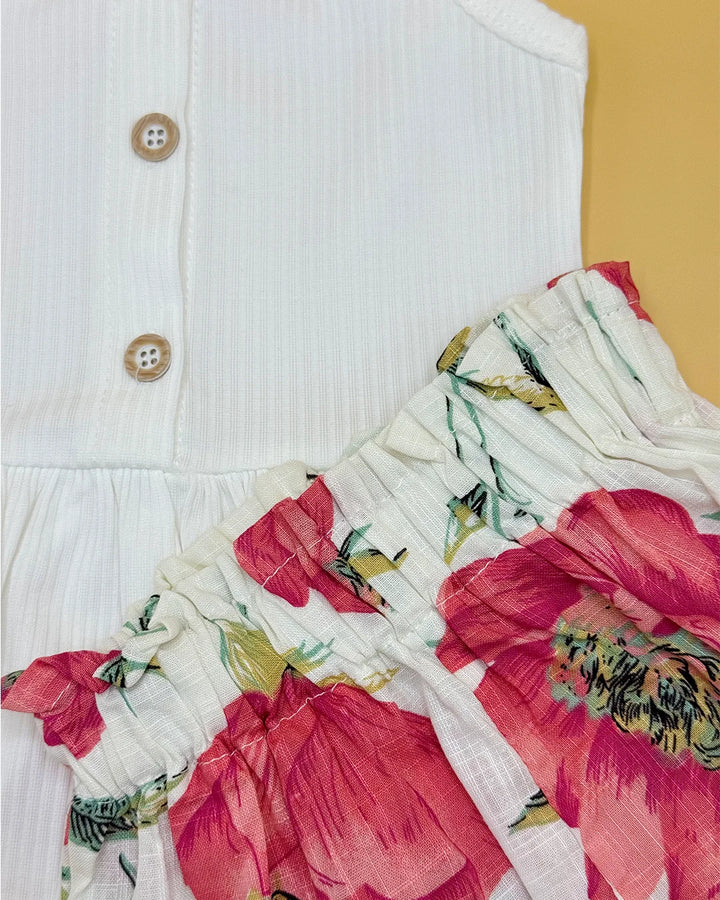 White dress with floral sleeves against a yellow background