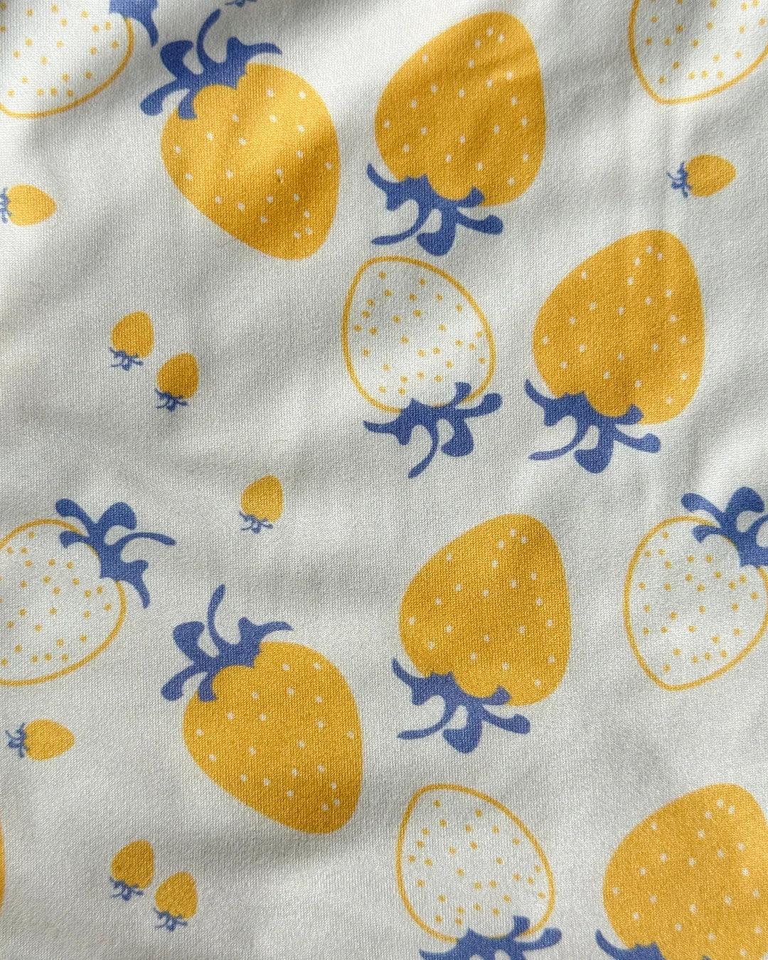 Pattern of yellow strawberries with blue stems on a white background
