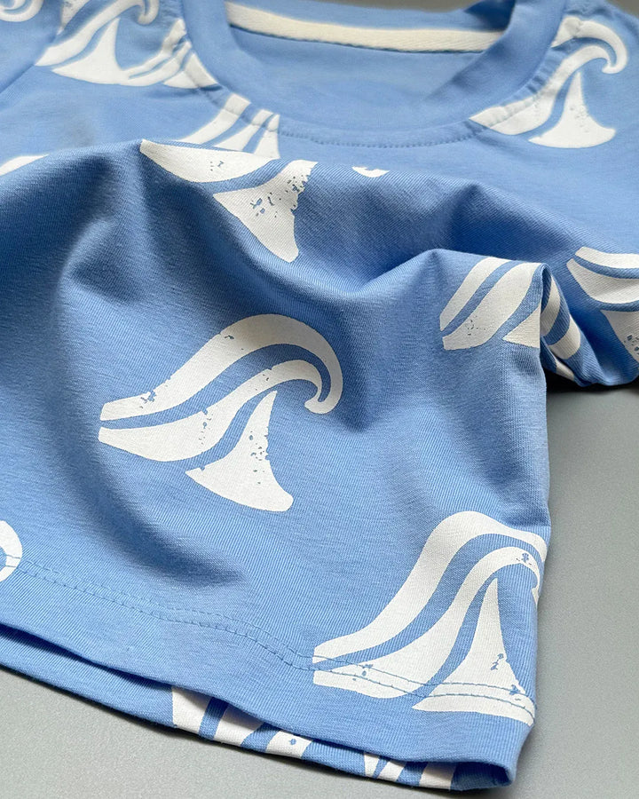 Blue fabric with white wave patterns on a gray surface