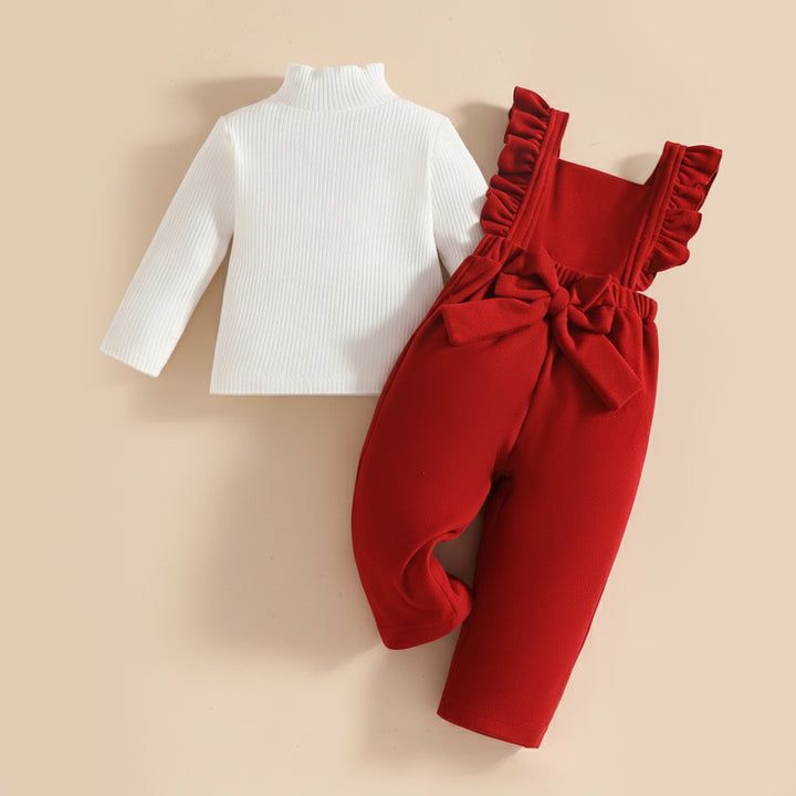 White long-sleeve top and red romper with ruffles on a beige background