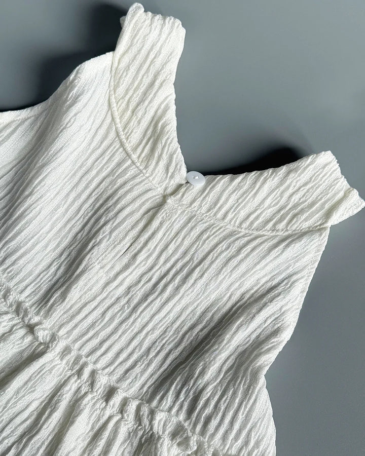 White textured dress on a gray background