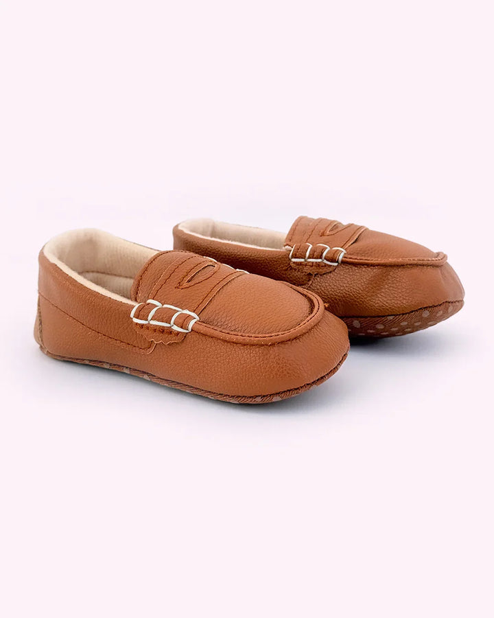 Pair of brown loafers on a white background