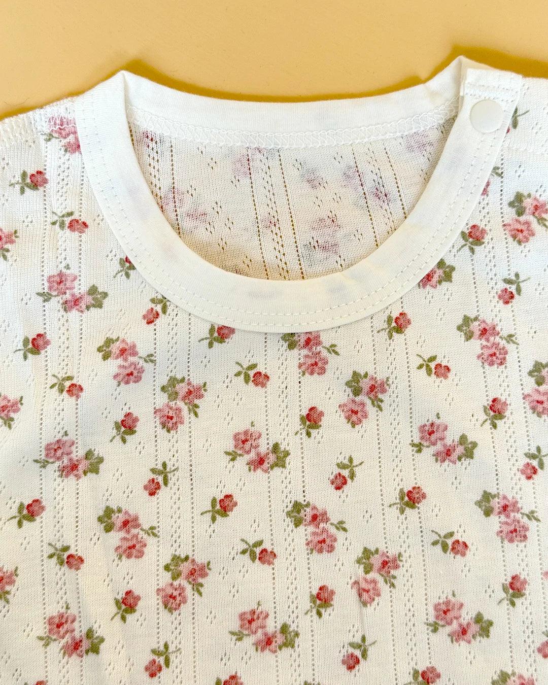 Close-up of a garment with a floral pattern on a beige background