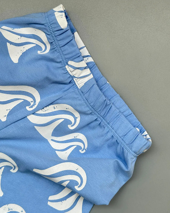 Blue shorts with white wave pattern on a gray background