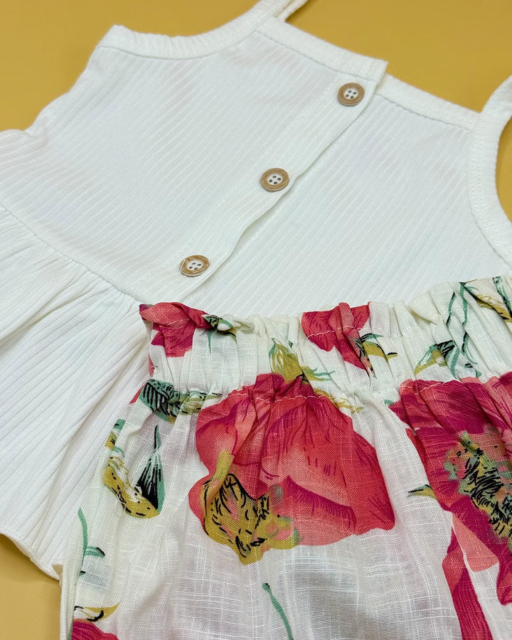 White cardigan with floral skirt on a yellow background