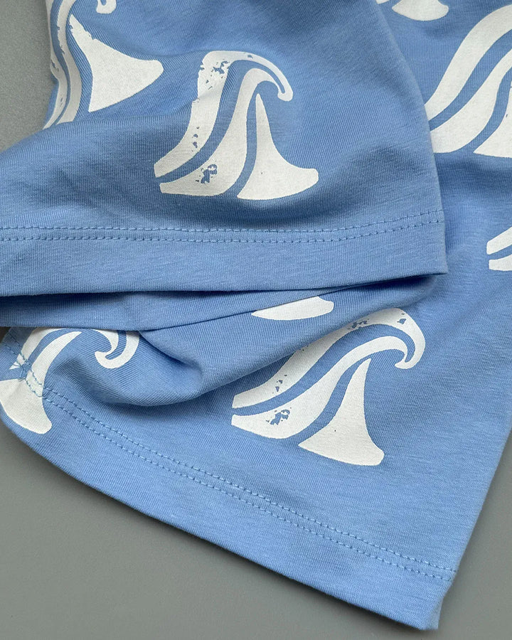 Blue fabric with white wave pattern on a gray background