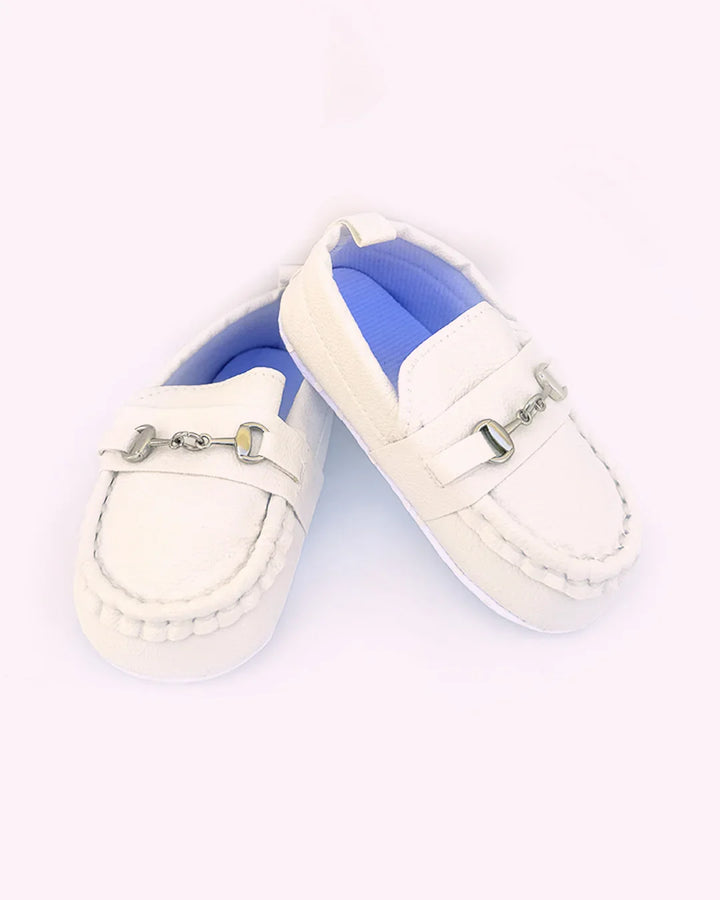White baby shoes with blue soles on a white background