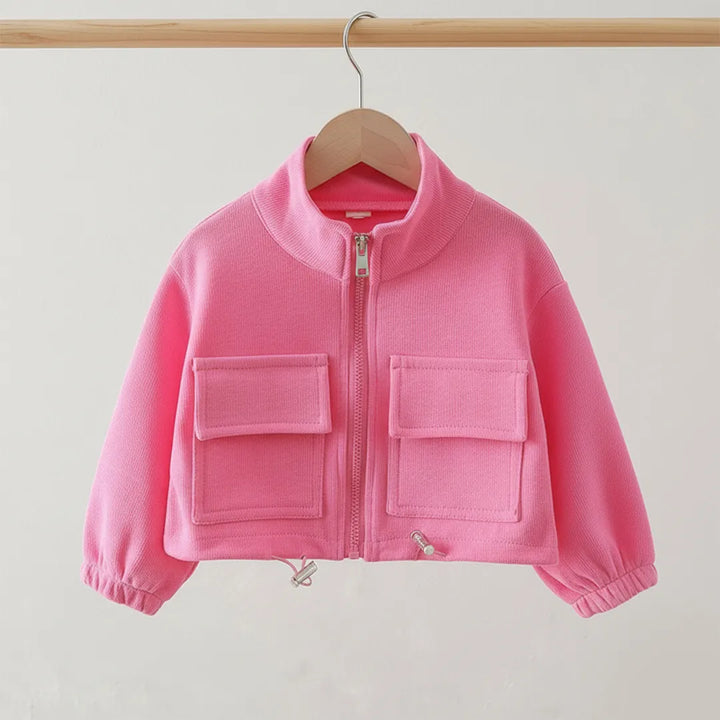 Pink jacket with two front pockets on a wooden hanger against a light gray background