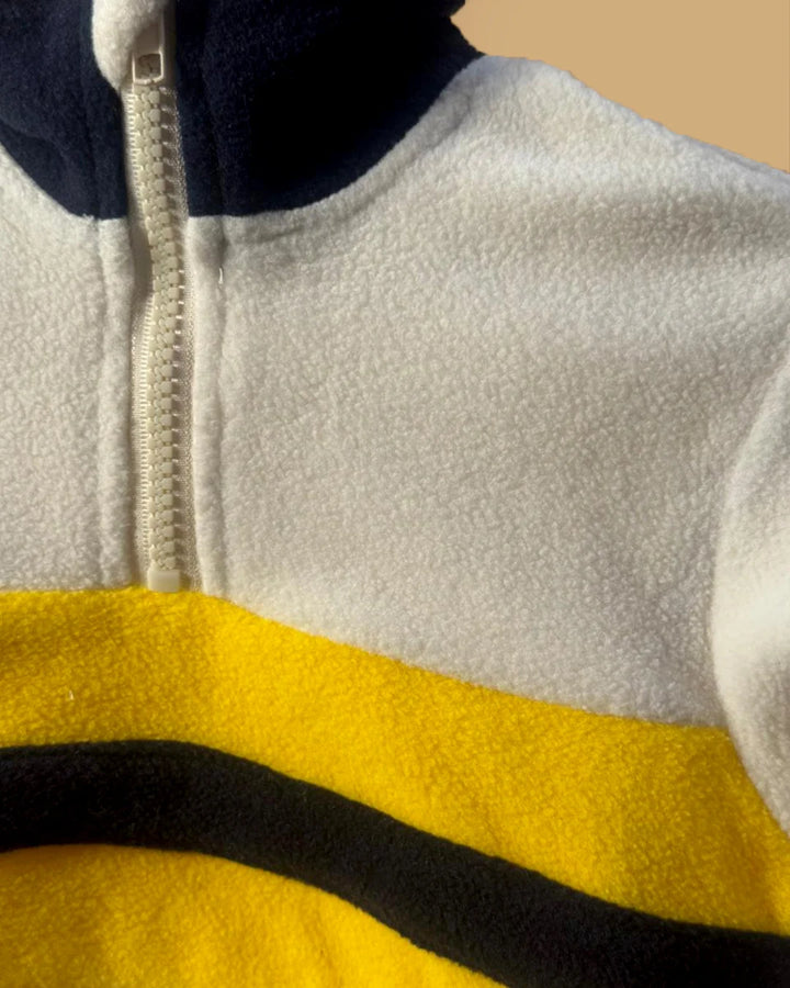 Close-up of a fleece jacket with a zipper and color-block design.