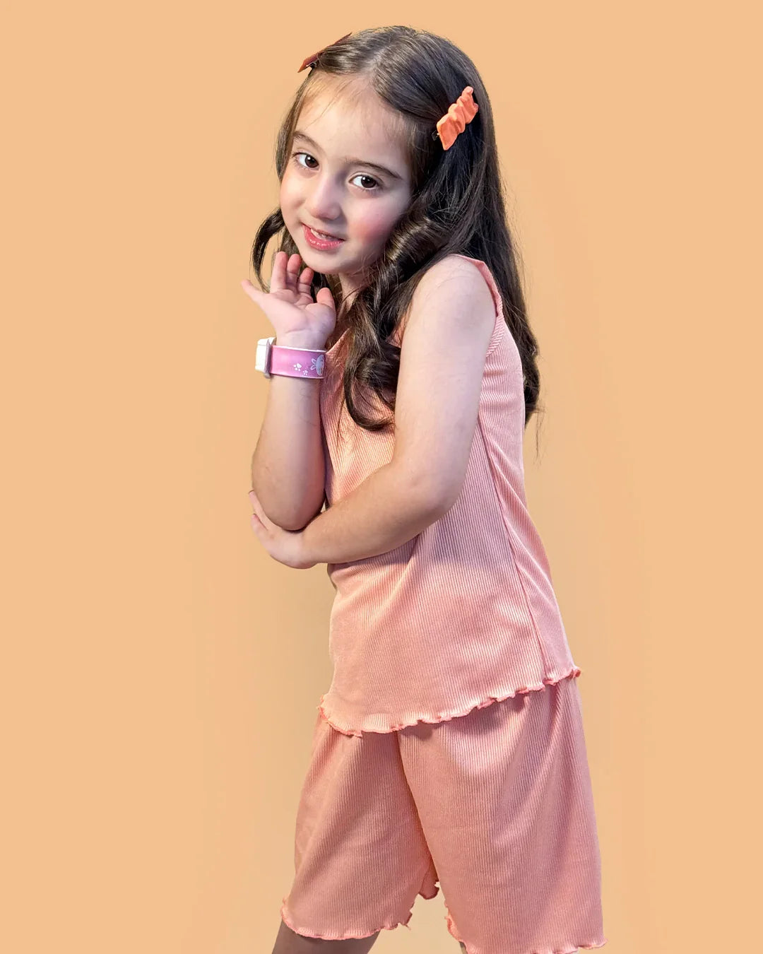 Young girl wearing a pink outfit against a beige background