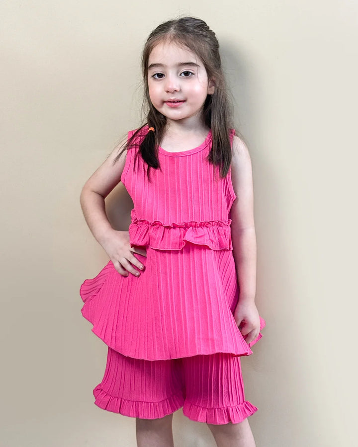 Young girl wearing a pink dress against a beige background