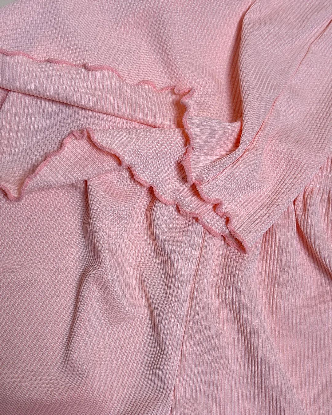 Close-up of pink fabric with ruffled edge