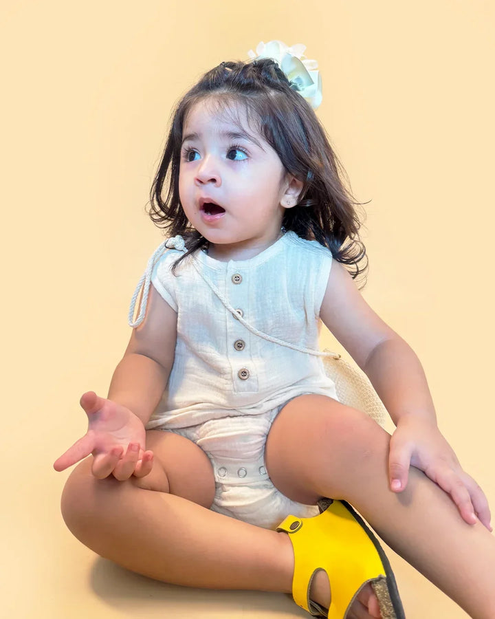 Child wearing a diaper with a yellow label on a beige background