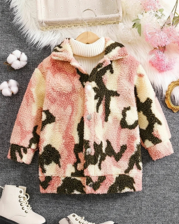 Camouflage-patterned jacket on a hanger with decorative items in the background